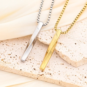 Detail of silver and gold rectangular pendants on box chains with polished finish