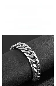 Detail of silver-toned stainless steel Cuban link bracelet with high-polish metallic finish
