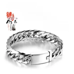 Macro detail of men's stainless steel Cuban link bracelet with wide folding clasp
