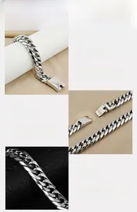 Detail view of silver stainless steel curb chain bracelet with secure square clasp