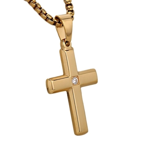 Close-up of golden cross pendant with sparkling zircon stone and elegant box chain