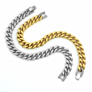 Close-up of gold and silver Cuban link bracelets with secure folding clasps