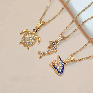 Detail of 316L stainless steel ocean pendants with 3A zircon stones and gold plating
