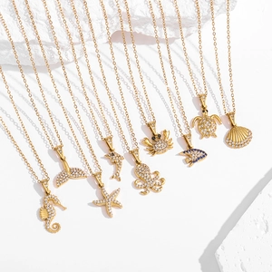 Detailed view of nine gold ocean-themed pendants with sparkling white zircon stones