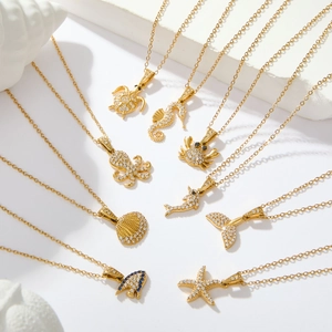 Gold ocean themed necklaces featuring starfish and seahorse pendants with crystals