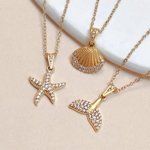 Gold ocean necklaces set with starfish shell and whale tail pendants with cubic zirconia