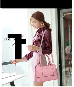 Litchi texture pink handbag with contrast trim and crossbody strap on a model