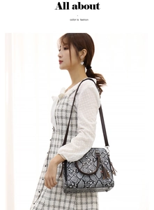 Detail of snake pattern handbag with elegant tassels and detachable shoulder strap