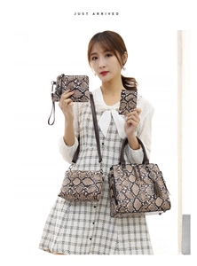 Detail of four-piece brown snake skin pattern handbag set including tote and crossbody bag