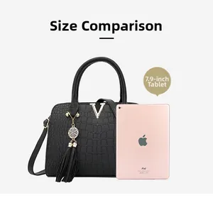 Comparison of black crocodile pattern handbag with a 7.9-inch tablet for size scale