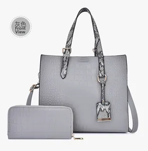 Close-up of grey embossed crocodile pattern tote bag and matching long wallet set