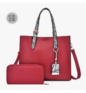Detail of red embossed crocodile pattern tote bag and matching zip wallet set