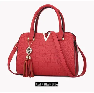 Red crocodile embossed handbag with golden V logo and stylish leather tassel detail