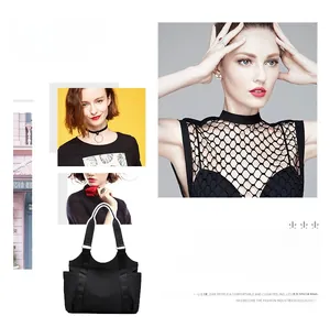 Detailed view of black Oxford cloth tote bag showing side pockets and wide straps