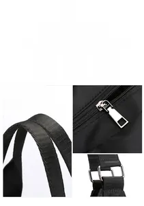 Detail of durable silver hardware and black nylon straps on a large tote bag