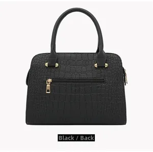 Rear view of black crocodile pattern leather handbag with back zipper and gold hardware
