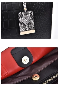 Detail of crocodile embossed leather bag with snake skin charm and gold magnetic closure