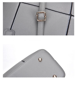 Detail of grey lychee leather texture with gold metal buckle and studs on bag