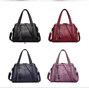 Detail view of four color options in V-quilted soft leather with woven handles and cat charms