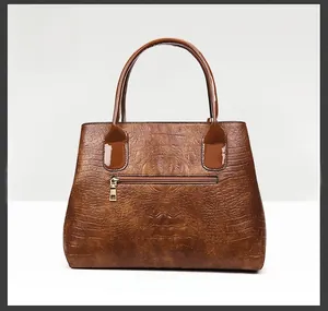 Detailed back view of a brown crocodile pattern tote bag with a golden metal zipper pocket