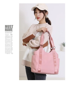 Pink large-capacity oxford tote bag featuring reinforced straps and side pockets detail