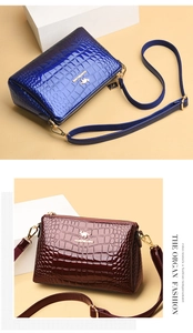 Detail of crocodile-embossed patent leather bags in royal blue and burgundy red colors