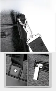 Detail of lychee pattern leather men's briefcase with silver hooks and metal zippers