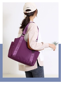 Side view of large purple oxford fabric tote bag worn by model for casual daily use