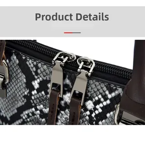 Close-up of snake skin texture handbag with dual metal zippers and leather pullers
