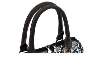 Detailed close-up of snakeskin pattern handbag with brown handles and silver zippers