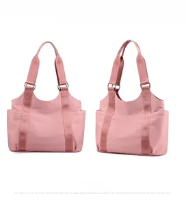 Detailed front and side view of pink oxford tote bag with wide straps and side pockets