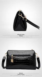 Detail of black patent leather crossbody bag with crocodile texture and gold kangaroo zipper