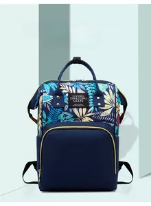 Detail of multi-functional mommy backpack with tropical leaf prints and spacious zip pockets