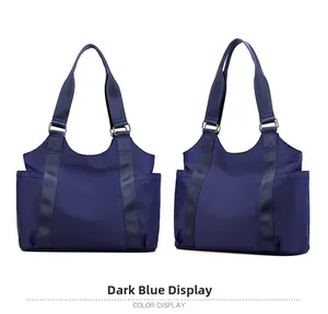 Detail view of the deep blue Oxford fabric tote bag with reinforced handles and side pockets