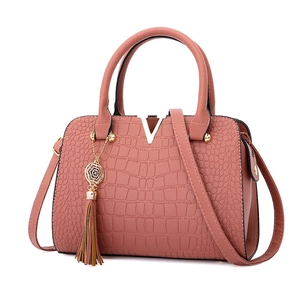 Elegant mauve crocodile pattern handbag for women with gold V-logo and tassel detail