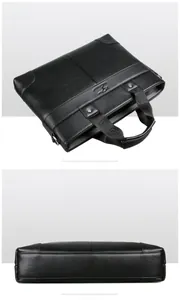 Macro detail of high-quality lychee grain leather and kangaroo logo on black briefcase
