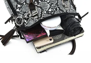 Top view of snake pattern handbag showing large interior space and daily essentials