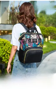 Detail of waterproof mommy backpack featuring tropical floral print and black fabric