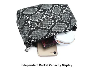 Internal view of snakeskin pattern bag showing storage space for phone and makeup