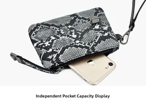 Close-up of compact grey snake-skin textured pouch with silver zipper and wristlet strap