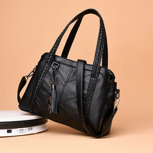 Black pebbled PU leather tote bag with woven handles and fringe detail for women