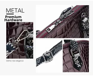 Detailed view of silver hardware and crocodile pattern texture on wine red shoulder bag