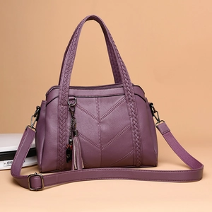 Purple faux leather tote bag with V-shaped stitching, woven handles and tassel detail