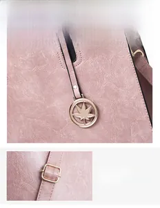 Detail of pink lychee leather handbag with light gold maple leaf charm and metal buckle