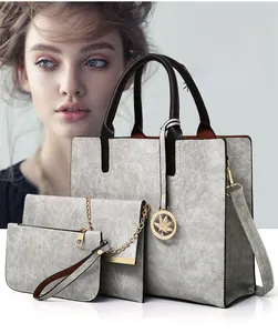 Detailed set of grey crackle texture PU leather tote, chain bag, and clutch with leaf charm