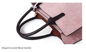 Detail of pink vintage textured leather handbag with brown handles and gold zipper hardware