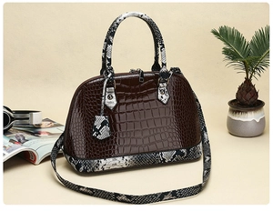 Detail of dark brown faux crocodile and snake skin shell bag with sturdy handles