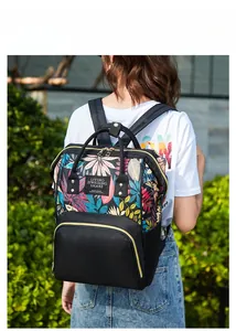 Outdoor shot of the colorful leaf-printed backpack featuring a durable black bottom base