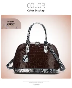 Detail of brown crocodile pattern handbag featuring contrasting snake skin straps and handles