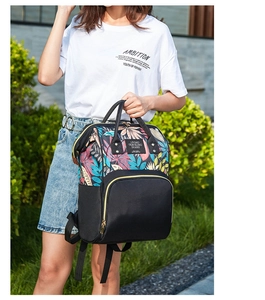 Close-up of stylish backpack with tropical floral prints and durable metal zippers